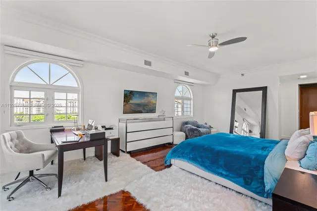a view of a hallway with wooden floor and a potted plant