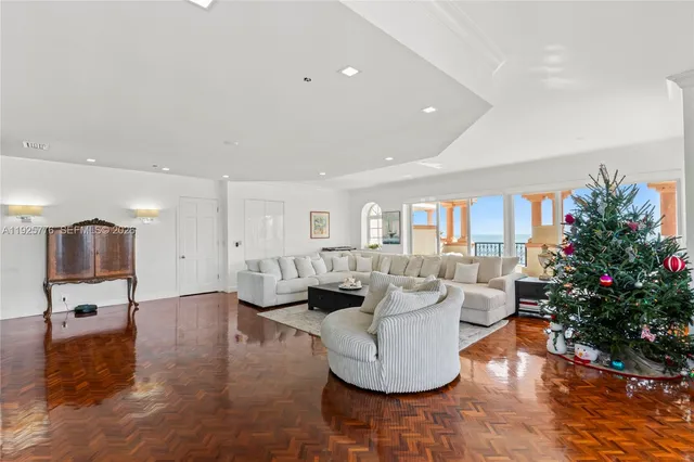 a living room with fireplace furniture and a potted plant