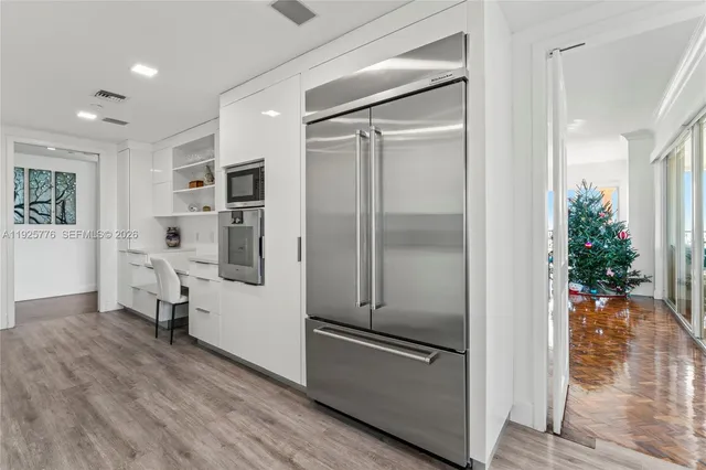 a kitchen with kitchen island a counter top space and wooden floor