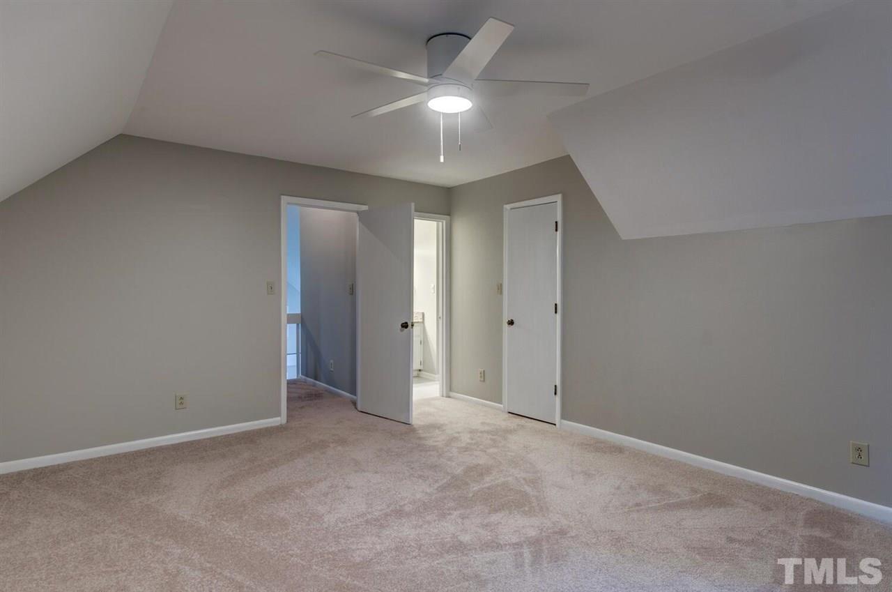 6329 Rushingbrook Drive Raleigh, NC 27612 - Photo 14 of 30 an empty room with a ceiling fan and a window