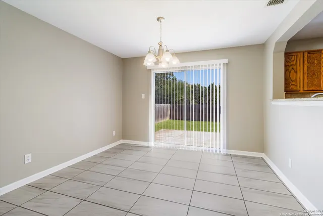 a view of an empty room with glass door