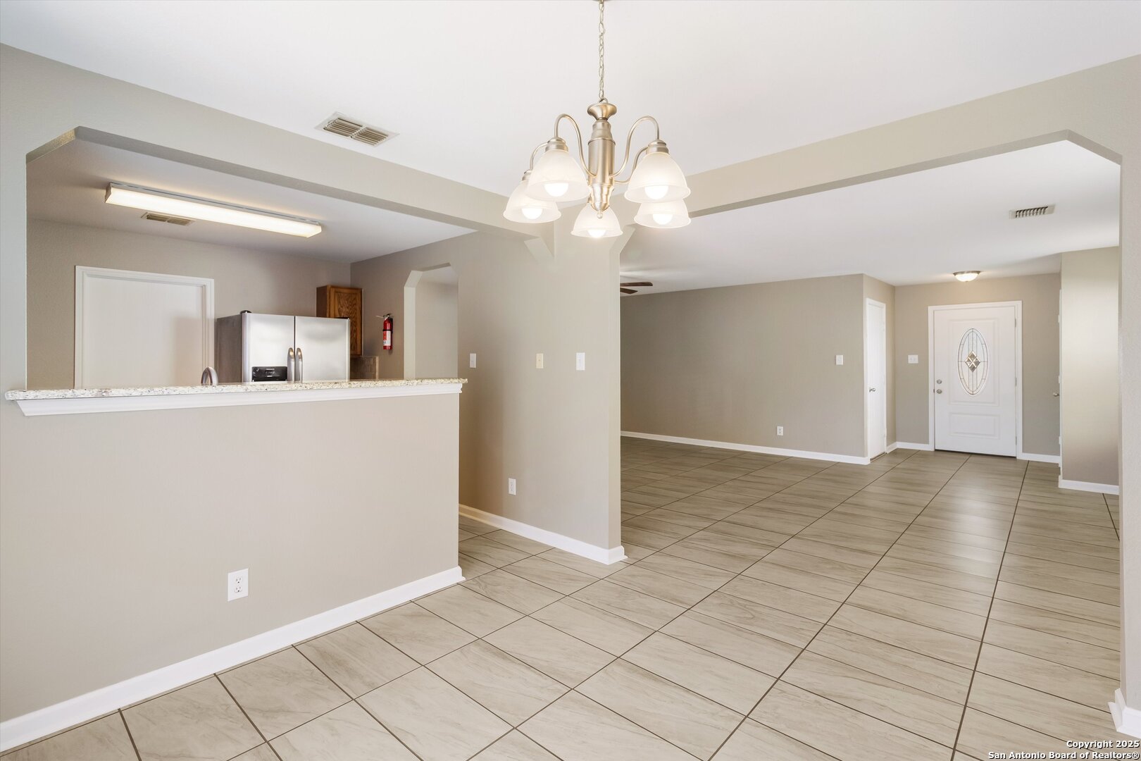 25002 Orchard Acres San Antonio, TX 78261 - Photo 12 of 29 a view of a kitchen with cabinet and a chandelier fan