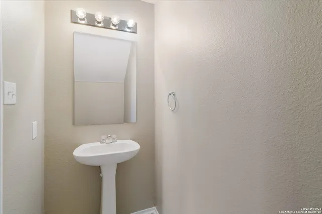 a bathroom with a sink and mirror