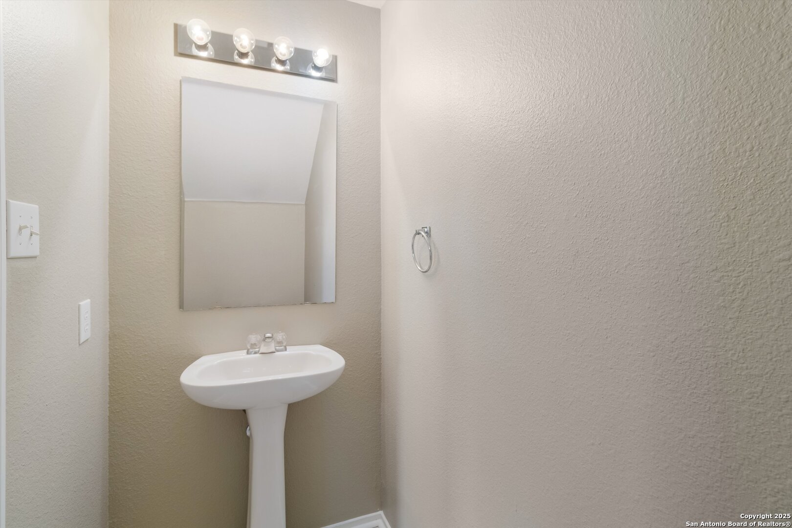 25002 Orchard Acres San Antonio, TX 78261 - Photo 13 of 29 a bathroom with a sink and mirror