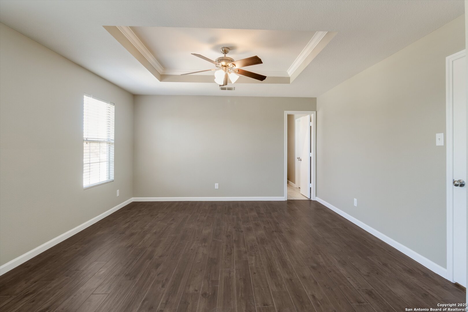 25002 Orchard Acres San Antonio, TX 78261 - Photo 14 of 29 an empty room with wooden floor chandelier fan and windows