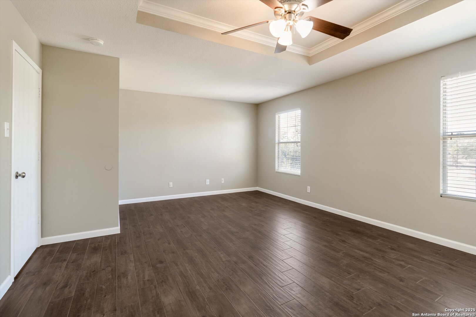 25002 Orchard Acres San Antonio, TX 78261 - Photo 16 of 29 an empty room with wooden floor chandelier fan and windows