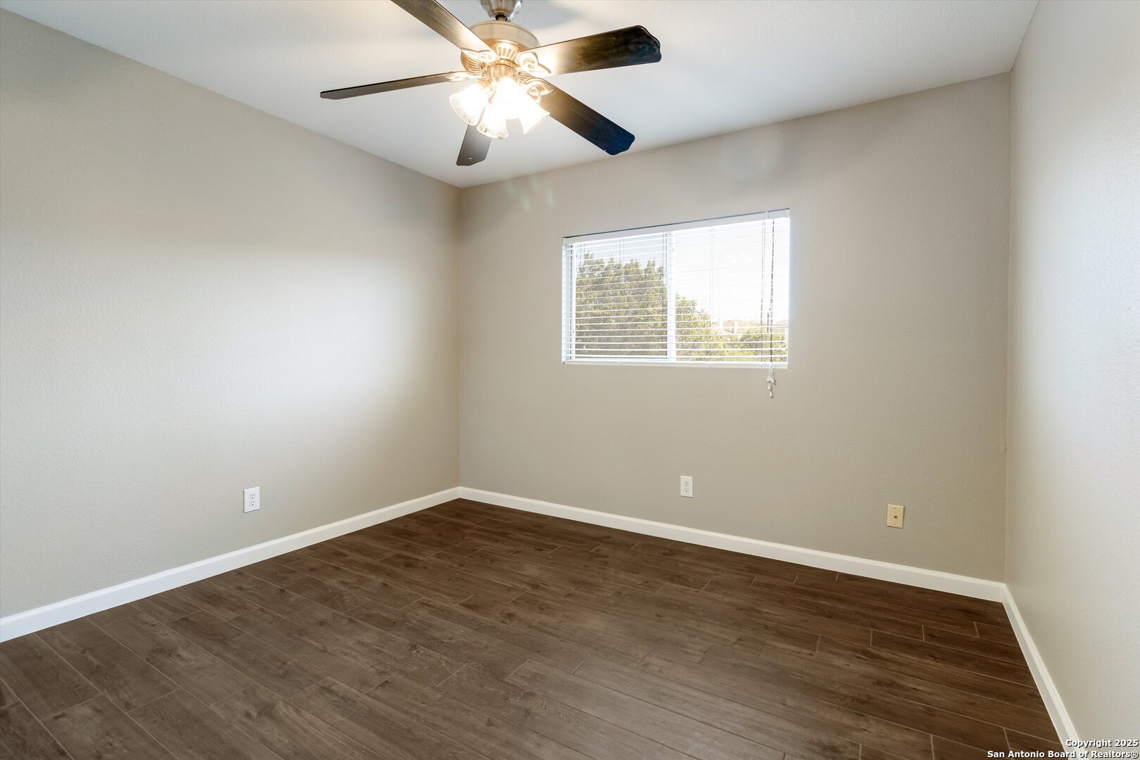 25002 Orchard Acres San Antonio, TX 78261 - Photo 23 of 29 an empty room with wooden floor chandelier fan and windows