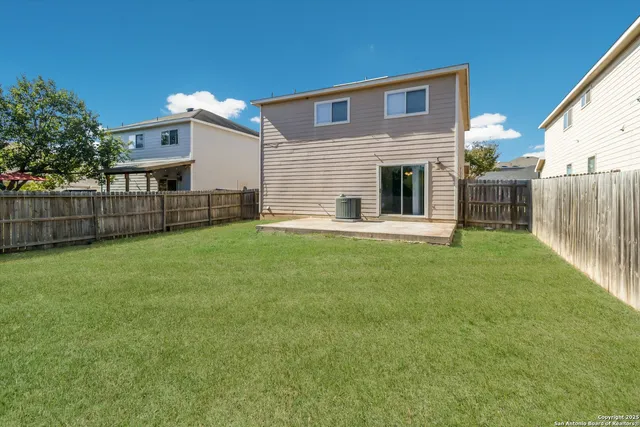 a front view of house with yard and fence