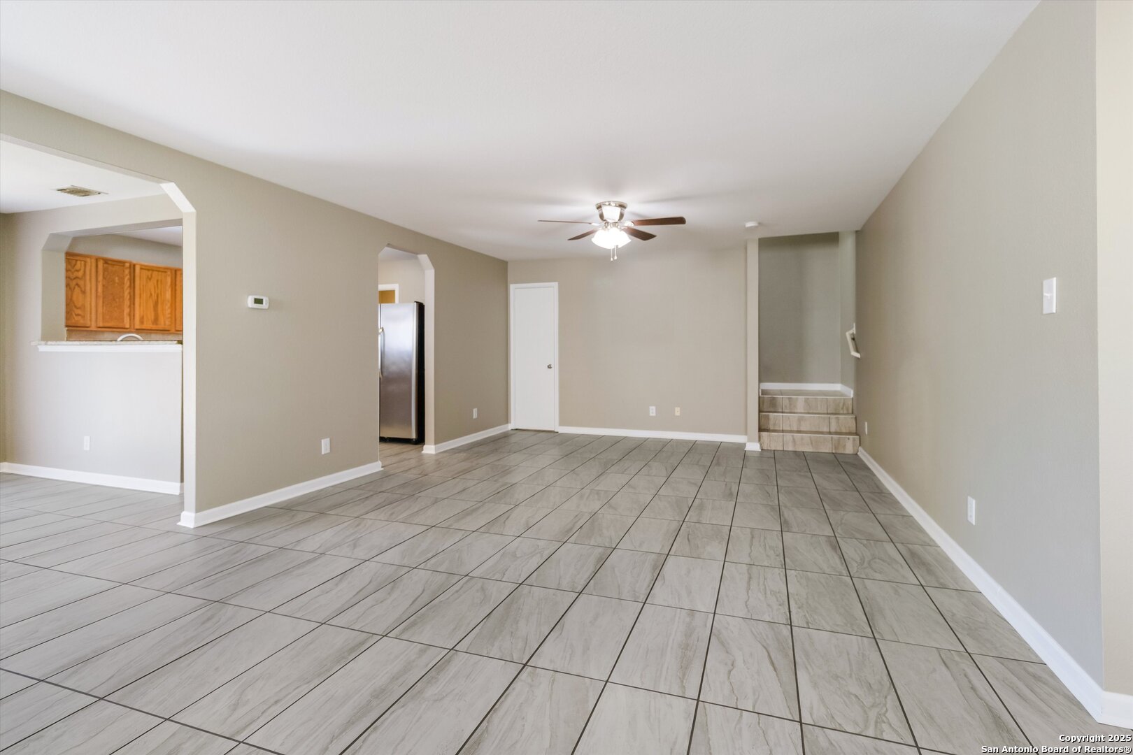25002 Orchard Acres San Antonio, TX 78261 - Photo 6 of 29 an empty room with windows and chandelier fan