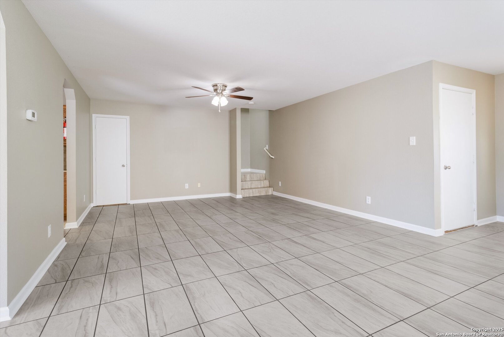 25002 Orchard Acres San Antonio, TX 78261 - Photo 7 of 29 an empty room with windows and chandelier fan