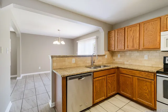 a kitchen with a sink stove and cabinets
