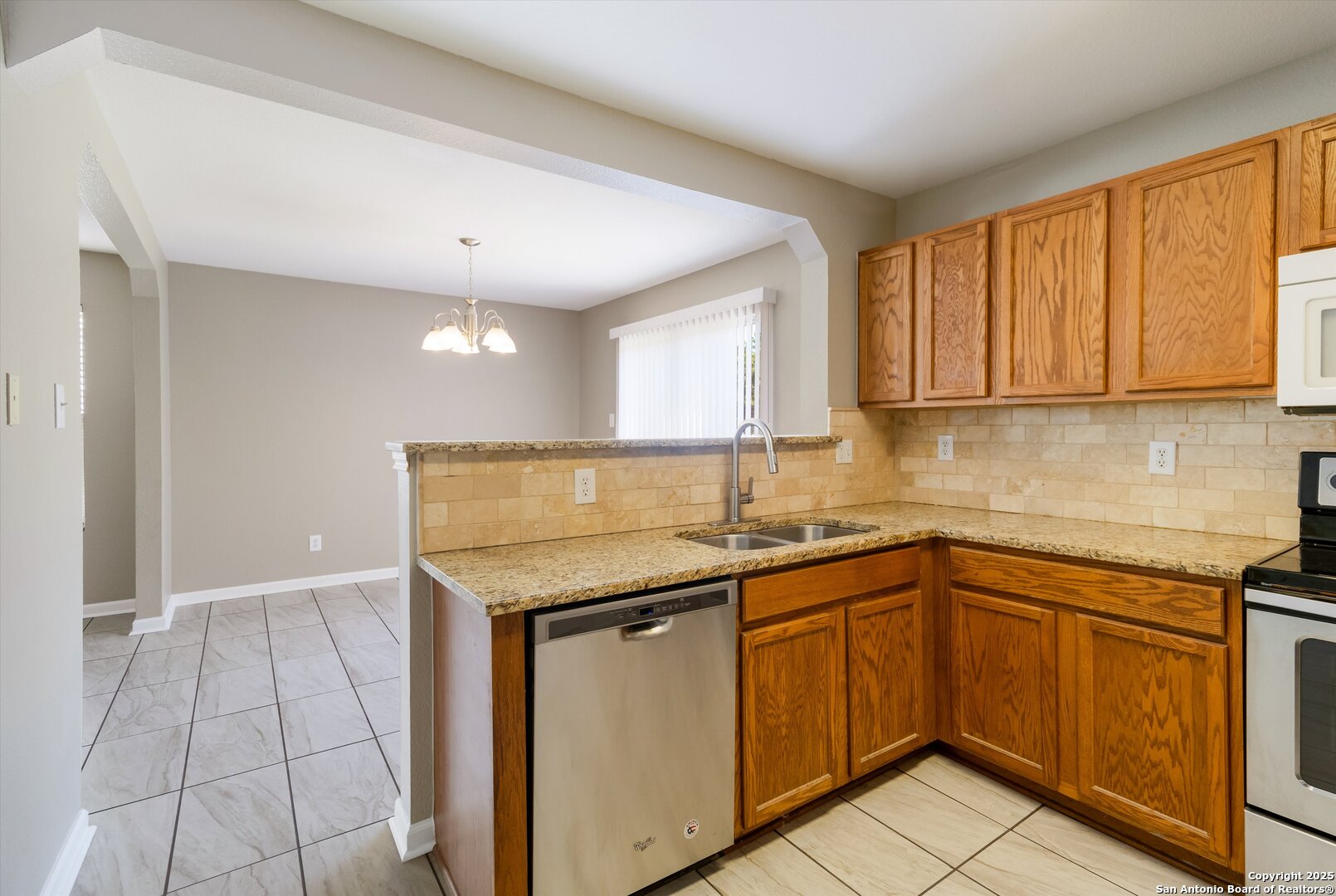 25002 Orchard Acres San Antonio, TX 78261 - Photo 10 of 29 a kitchen with a sink stove and cabinets