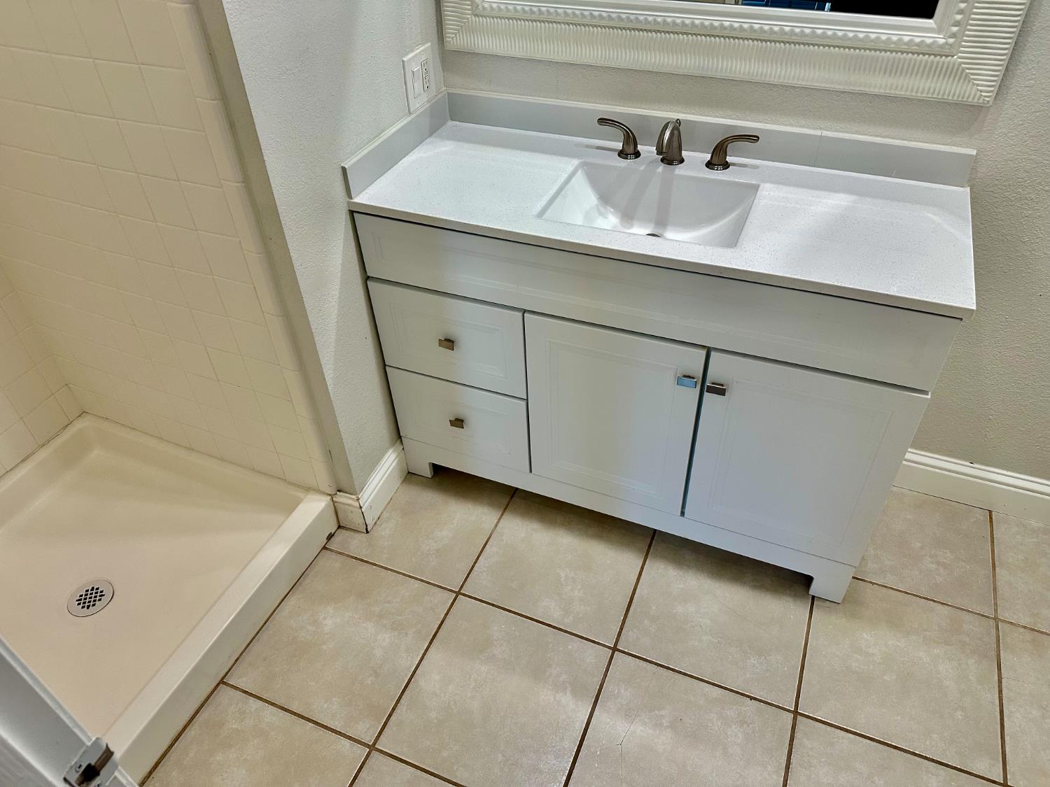 5683 North Rafael Avenue Fresno, CA 93711 - Photo 12 of 19 a bathroom with a sink and a shower