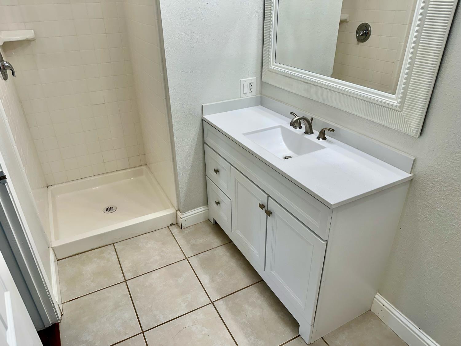 5683 North Rafael Avenue Fresno, CA 93711 - Photo 14 of 19 a bathroom with a shower sink and mirror