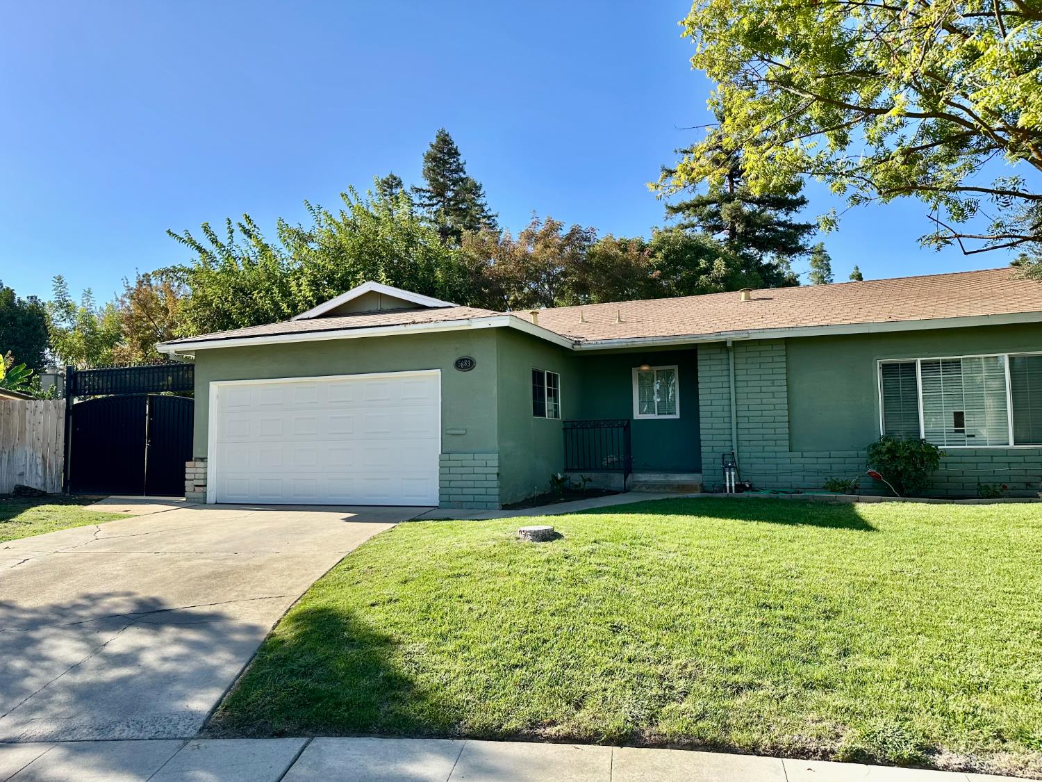 5683 North Rafael Avenue Fresno, CA 93711 - Photo 2 of 19 a front view of a house with yard and garage