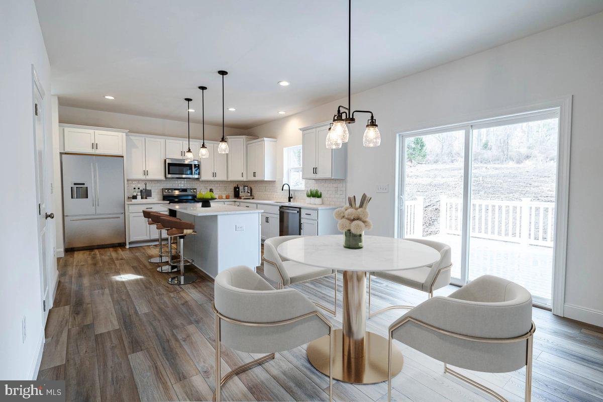 910 Freemansville Road Reading, PA 19607 - Photo 12 of 38 a living room with kitchen island furniture and a chandelier