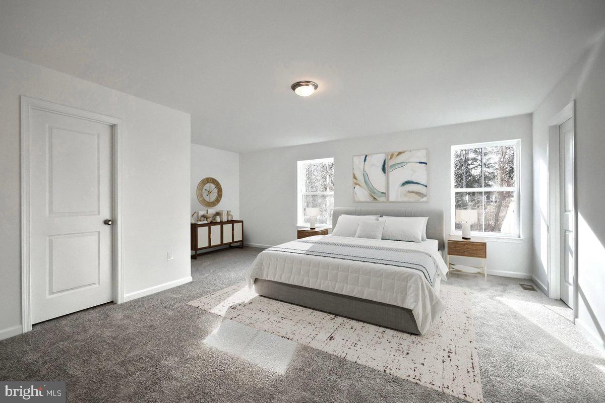 910 Freemansville Road Reading, PA 19607 - Photo 15 of 38 a spacious bedroom with a bed a table and a large window