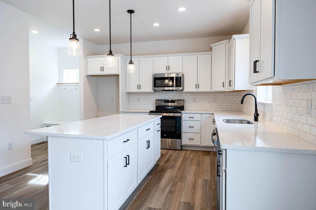 910 Freemansville Road Reading, PA 19607 - Photo 18 of 38 a kitchen with stainless steel appliances granite countertop a sink a stove a refrigerator and a oven with white cabinets