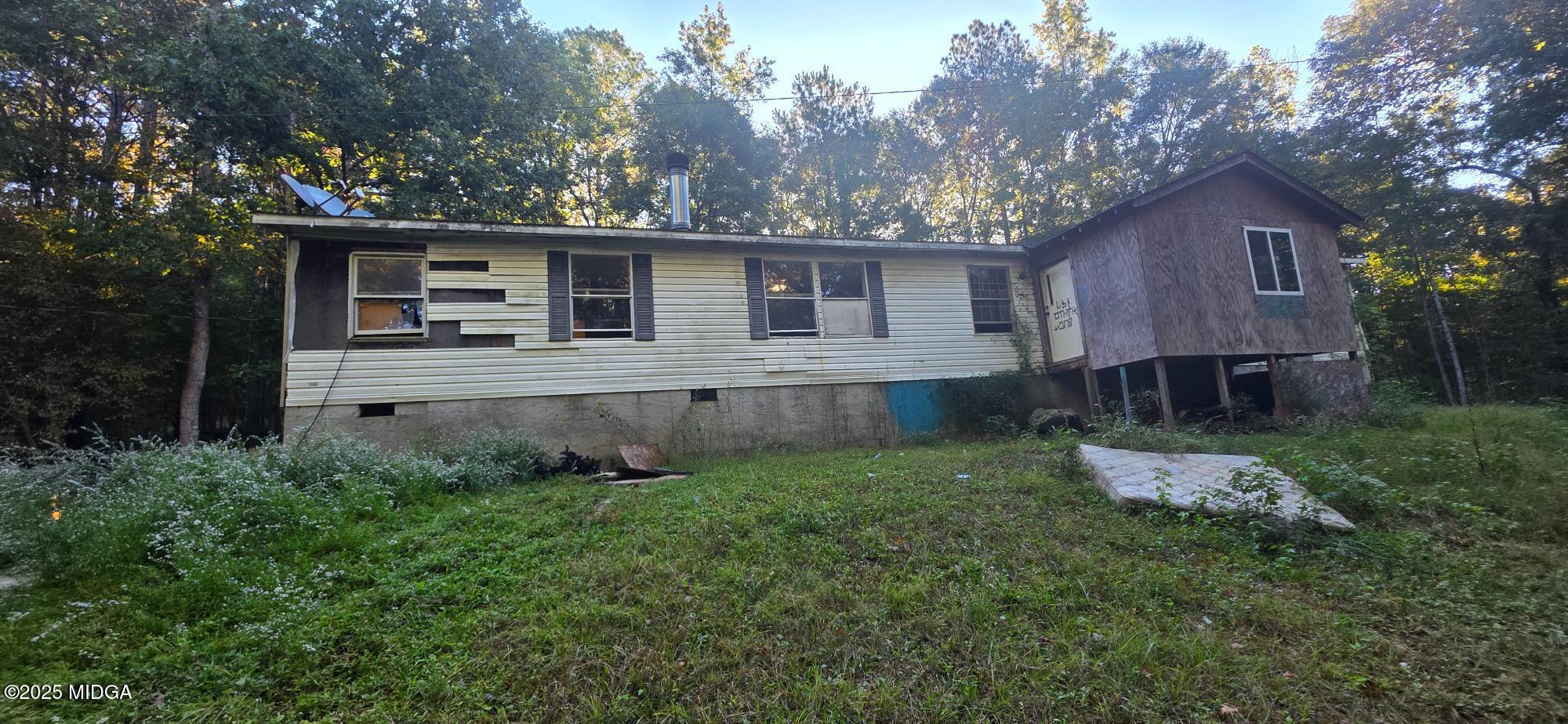 401 Towaliga Trail Forsyth, GA 31029 - Photo 23 of 30 a front view of a house with yard and trees