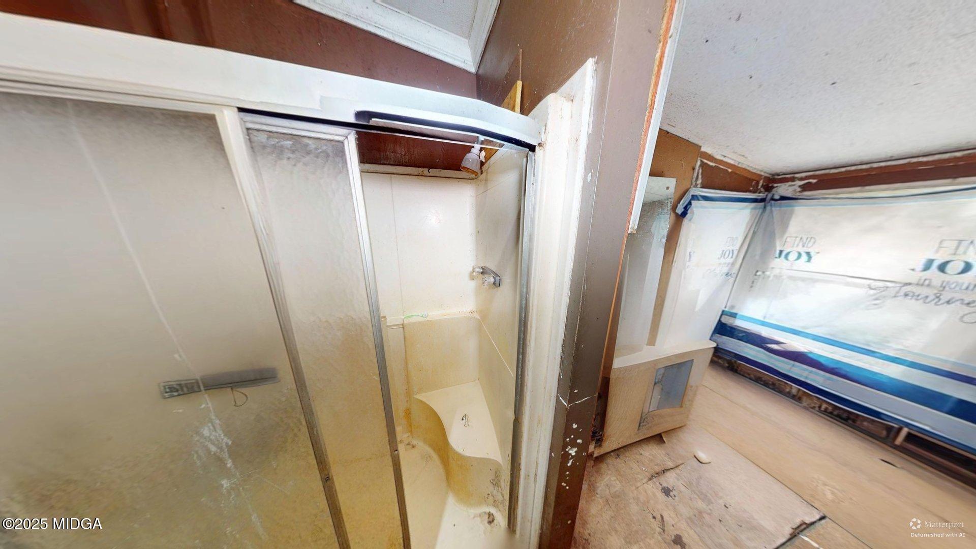 401 Towaliga Trail Forsyth, GA 31029 - Photo 10 of 30 a bathroom with a tub and a shower