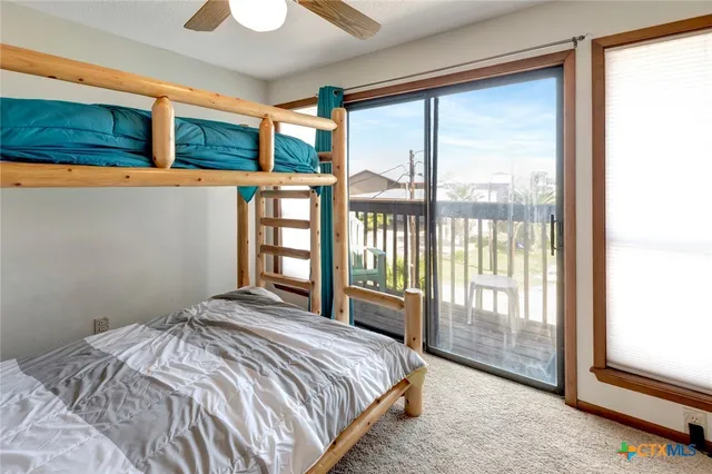 a bedroom with a large bed and a large window