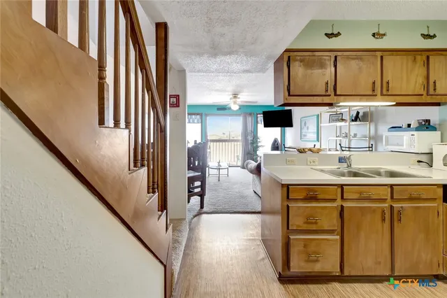 a kitchen with stainless steel appliances granite countertop a sink and cabinets