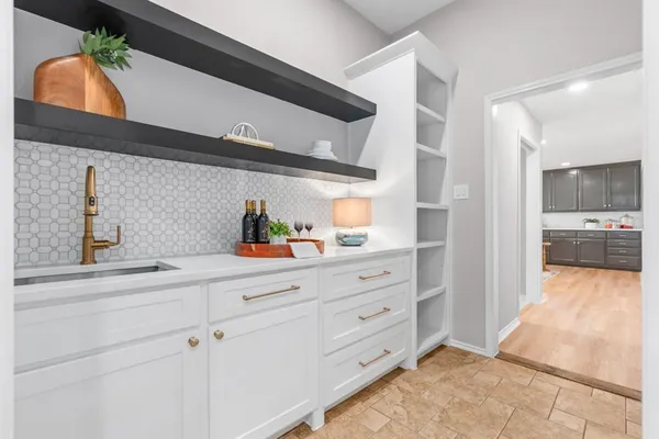 a kitchen with cabinets and window