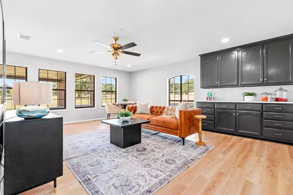 a living room with furniture a rug and a window
