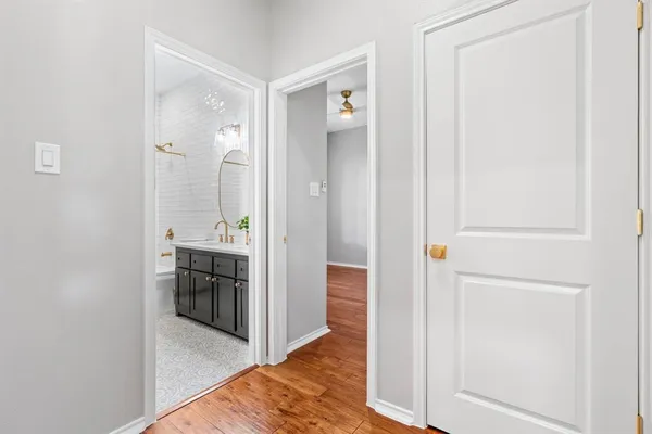 a bathroom with a toilet sink vanity granite and shower