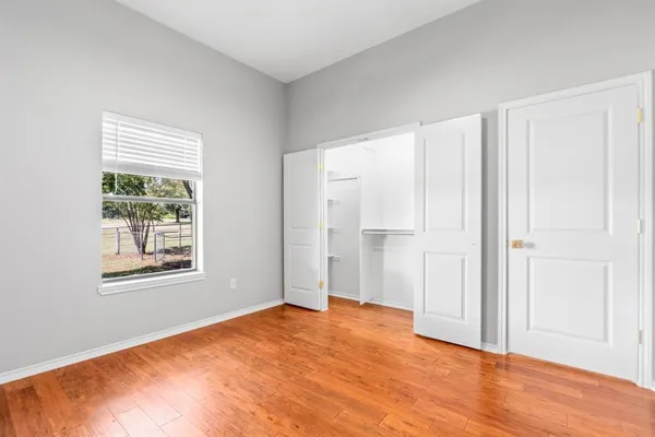 a bathroom with a granite countertop sink a toilet and a mirror