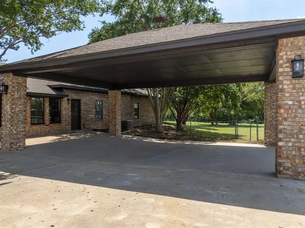 a view of a patio with a table chairs and a yard