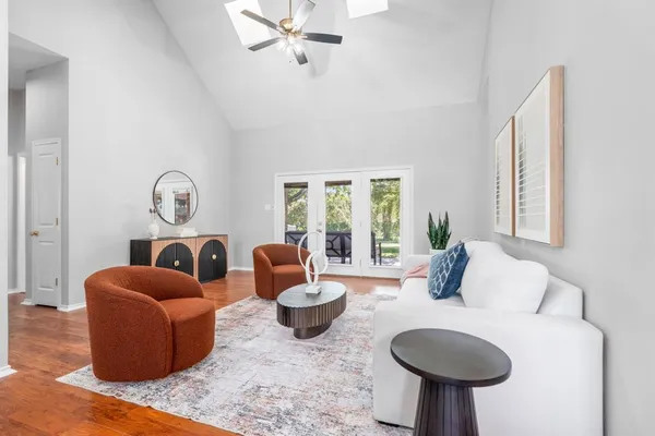 a living room with furniture a lamp and a large window