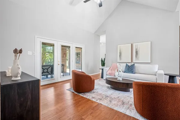 a living room with furniture and a wooden floor
