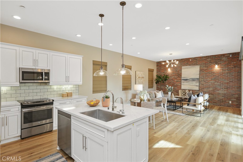245 Follyhatch Irvine, CA 92618 - Photo 11 of 44 a kitchen with a sink a counter top space a stove and cabinets