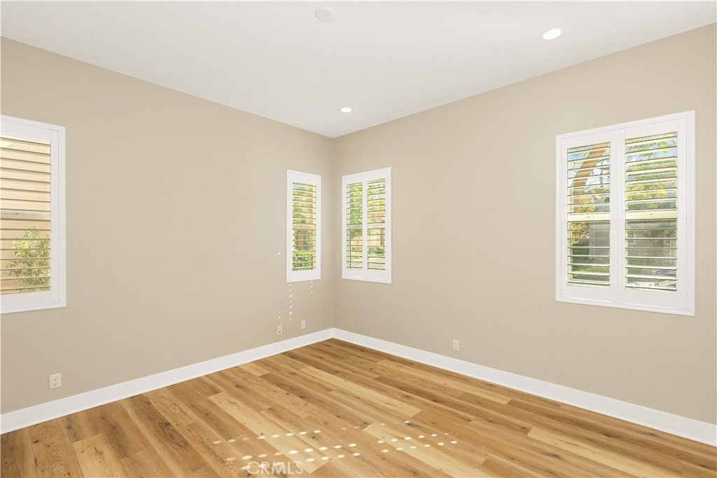 245 Follyhatch Irvine, CA 92618 - Photo 18 of 44 a view of an empty room with wooden floor and a window