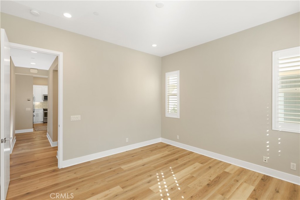 245 Follyhatch Irvine, CA 92618 - Photo 21 of 44 a view of empty room with wooden floor and fan
