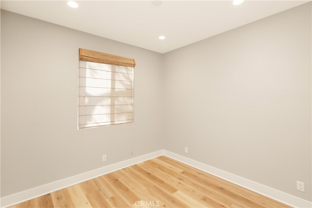 245 Follyhatch Irvine, CA 92618 - Photo 24 of 44 a view of an empty room with wooden floor and a window