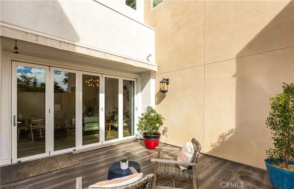 245 Follyhatch Irvine, CA 92618 - Photo 32 of 44 a balcony with table and chairs and potted plants