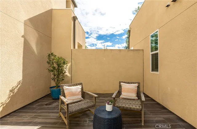 a balcony with table and chairs
