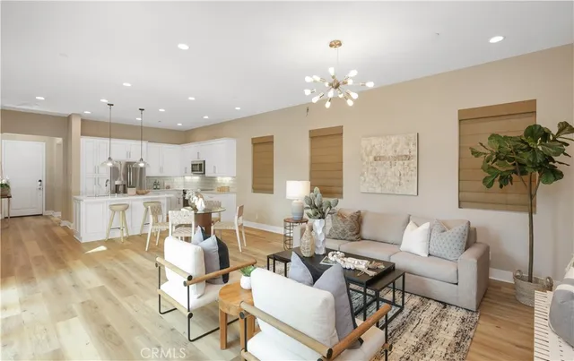 a living room with lots of furniture and a chandelier