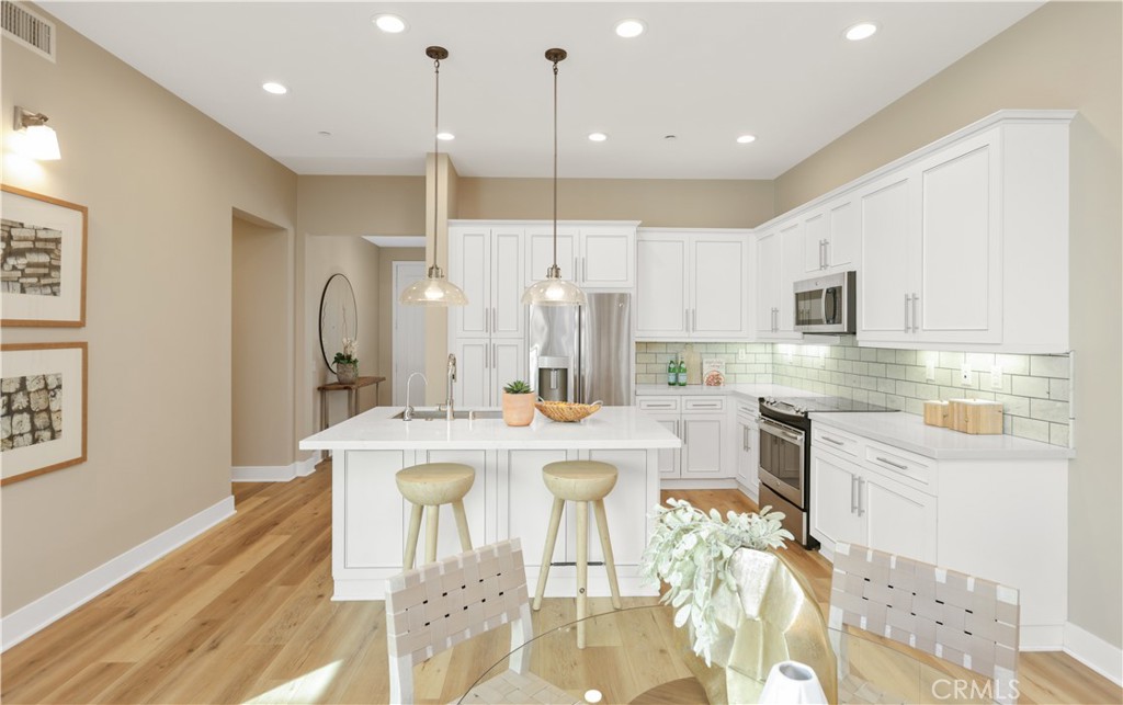 245 Follyhatch Irvine, CA 92618 - Photo 9 of 44 a large kitchen with a table and chairs