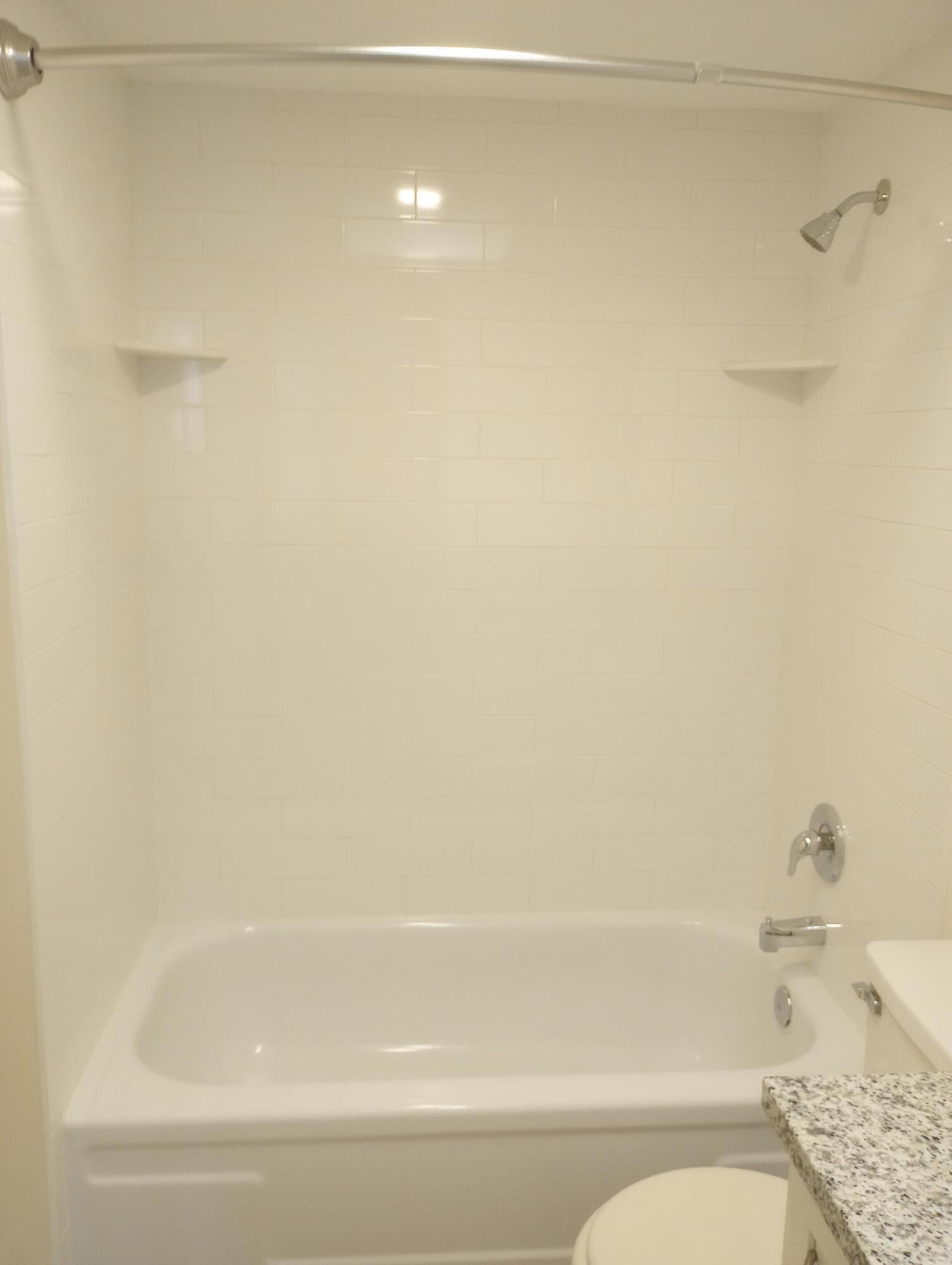 950 South Kanner Highway, Unit A21 Stuart, FL 34994 - Photo 19 of 24 a bathroom with a bathtub and a toilet