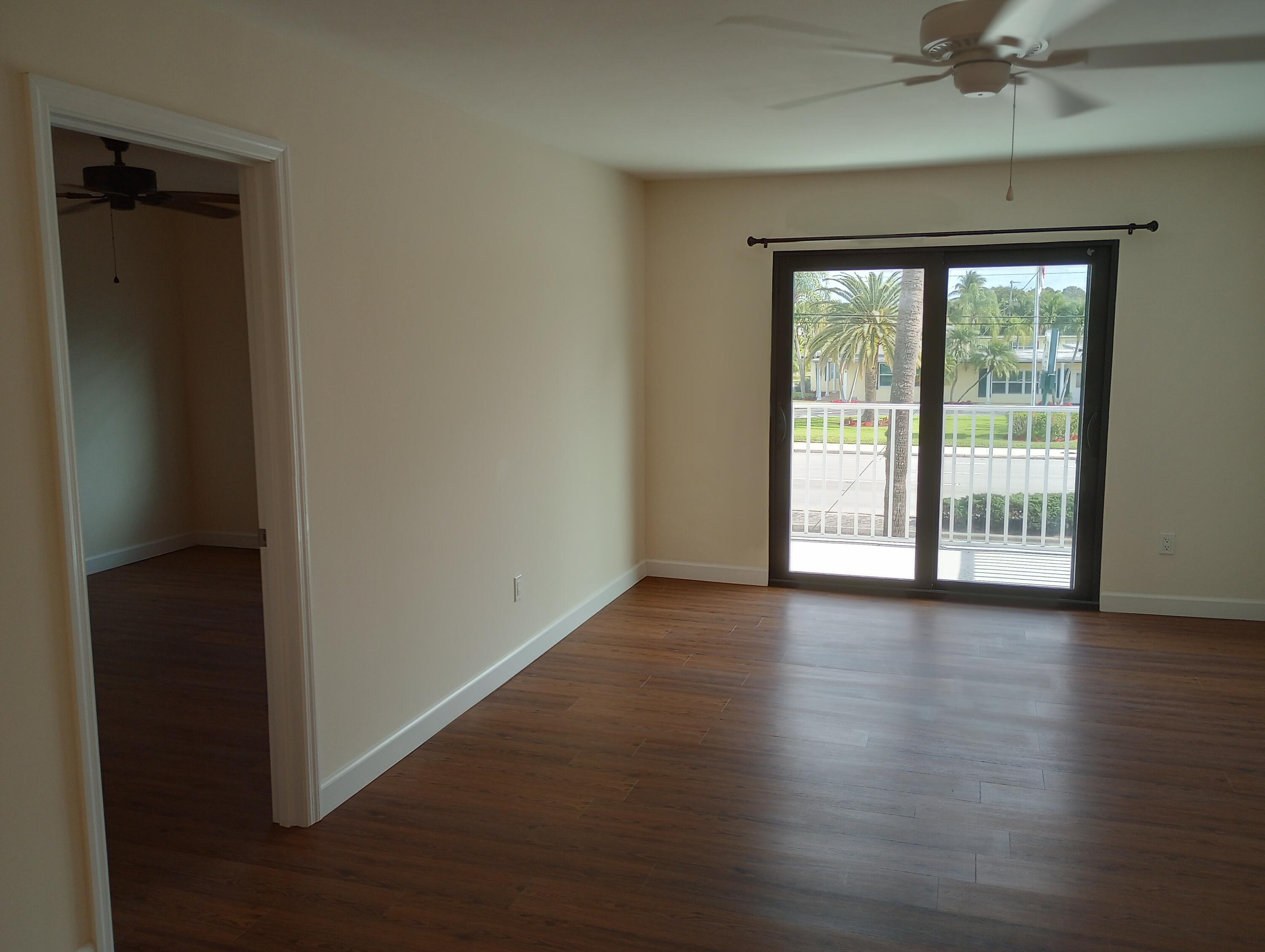 950 South Kanner Highway, Unit A21 Stuart, FL 34994 - Photo 6 of 24 an empty room with wooden floor and windows