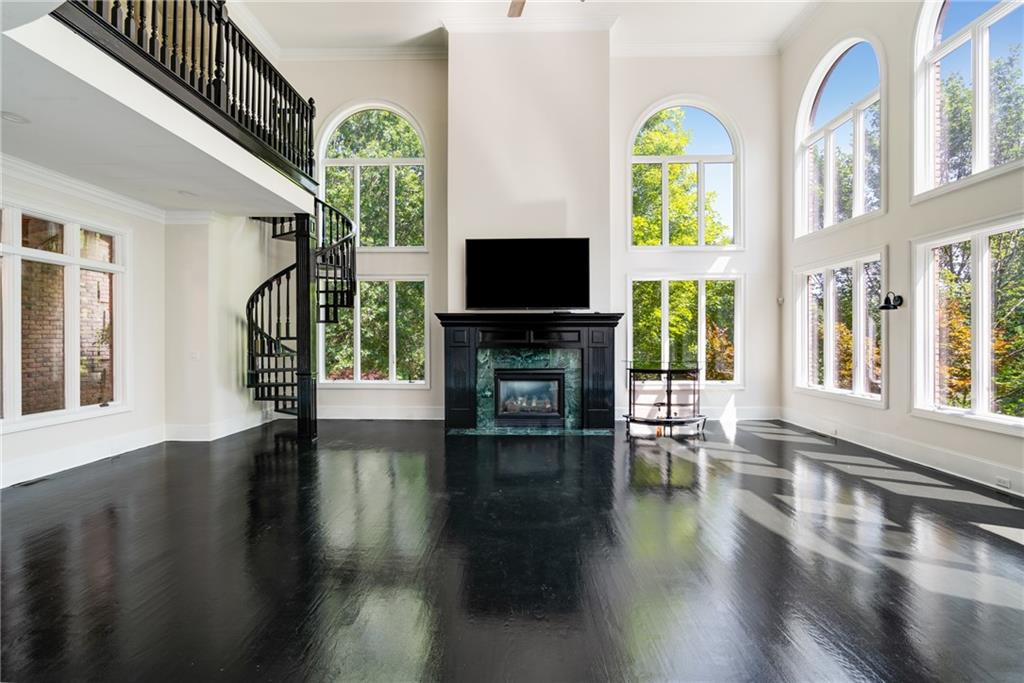 a living room with fireplace furniture and a wooden floor
