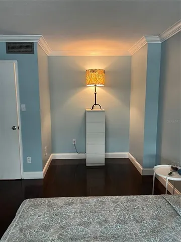 a view of a bedroom with wooden floor and bedroom