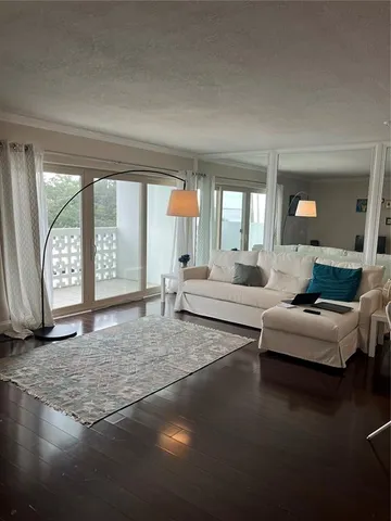 a living room with fireplace furniture and a large window