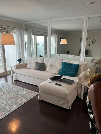 a living room with furniture and a large mirror