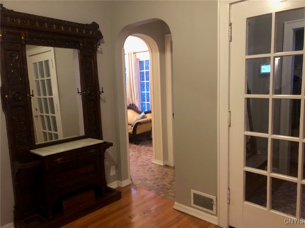 13 Brattle Road Syracuse, NY 13203 - Photo 8 of 48 turn right and note the powder room and the Sun/si