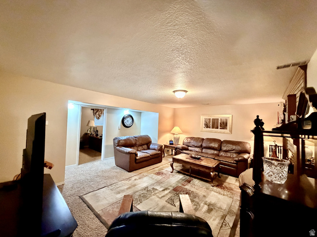 12080 Mill Ridge Circle Sandy, UT 84094 - Photo 30 of 56 Spacious entertainment room featuring recessed lighting, a neutral wall color, and textured carpeting
