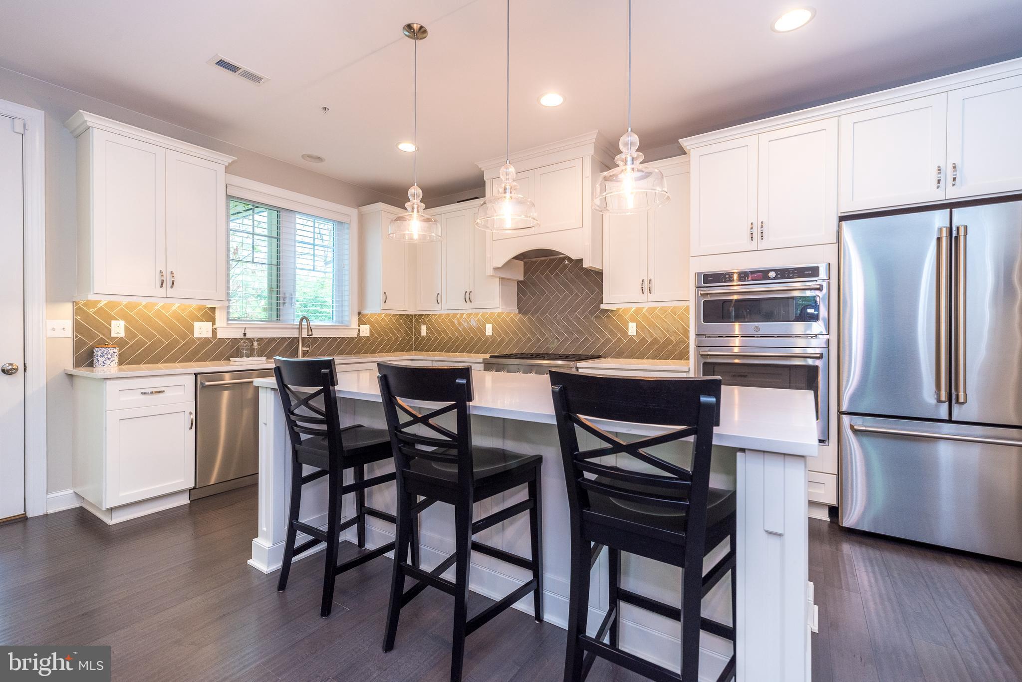 1 White Field Lower Gwynedd, PA 19002 - Photo 12 of 53 a kitchen with granite countertop a table chairs wooden floors and appliances